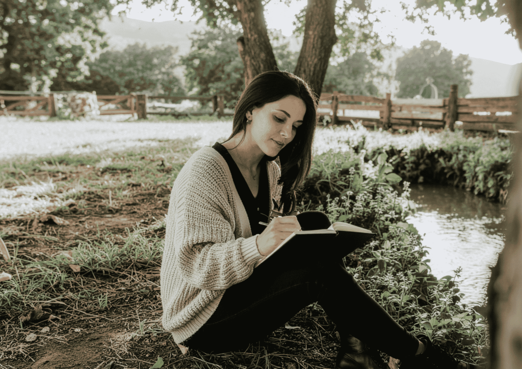 grieving mother writing in journal after pregnancy loss