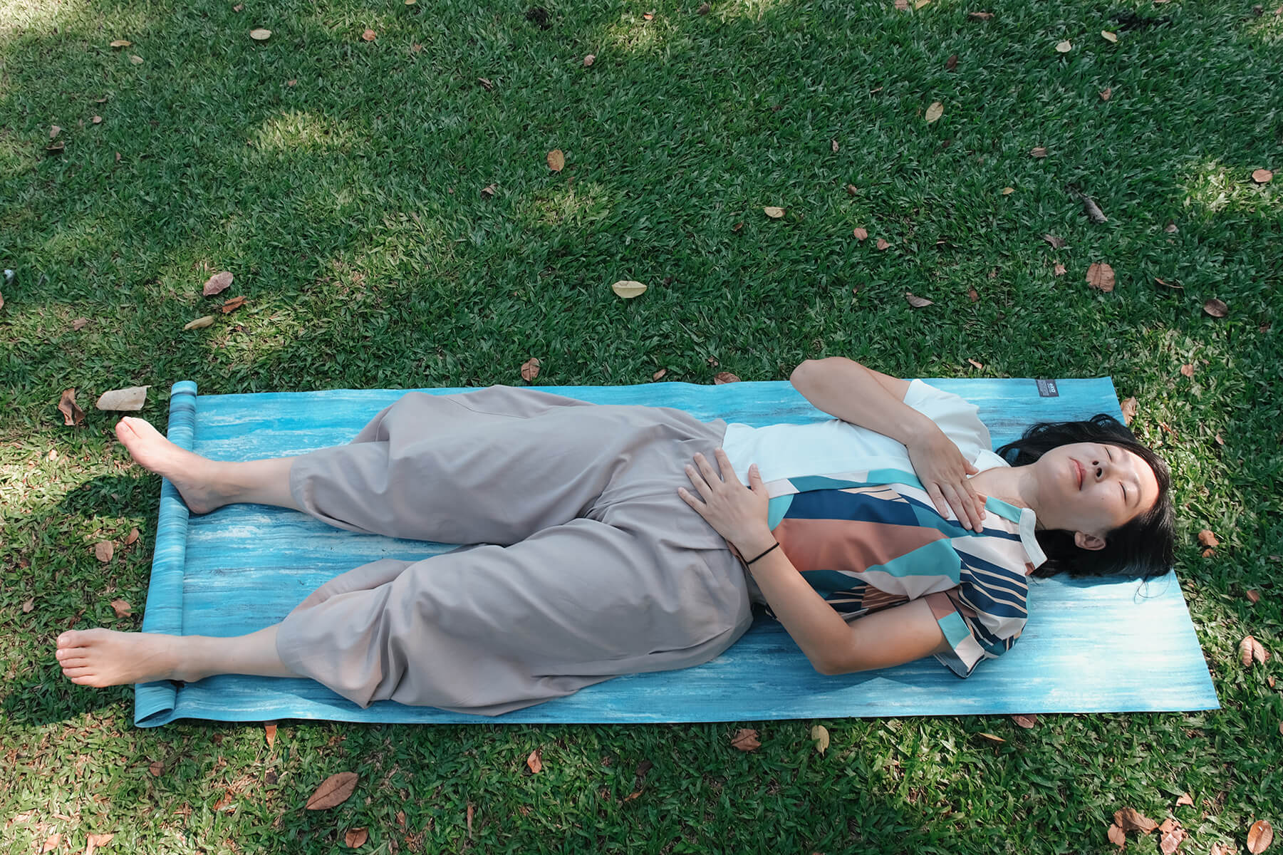 Vernessa Chuah practising TRE® in a peaceful outdoor garden setting